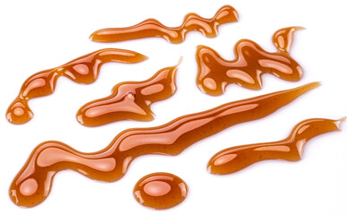 Sweet sugar caramel sauce curls isolated on white background. Top view.