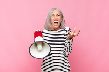 middle age woman looking angry, annoyed and frustrated screaming wtf or what‚Äôs wrong with you...