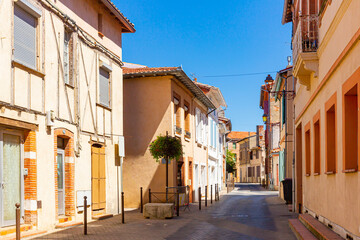 Picturesque view of old houses and streets of Muret town at sunny summer day, France