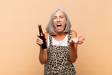 middle age woman looking angry, annoyed and frustrated screaming wtf or what‚Äôs wrong with you...