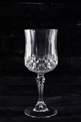 empty glass of wine on black background