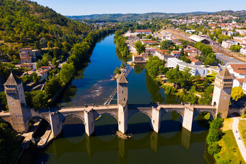 View from drone of medieval fortified arched Pont du Diable or Valentre bridge on river Lot in...