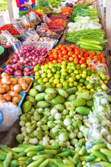 Food market with stall full of asian fruits and vegetables. Thailand fresh groceries