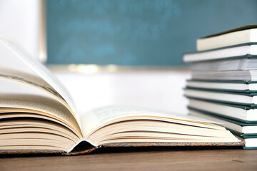Books opened in front of blackboard