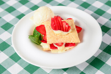 Napoleon cake with strawberries and vanilla ice cream. Italian cuisine concept, traditional Italian summer dessert.