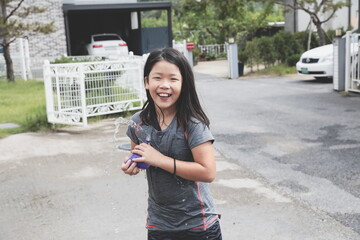 a girl happy with a water balloon