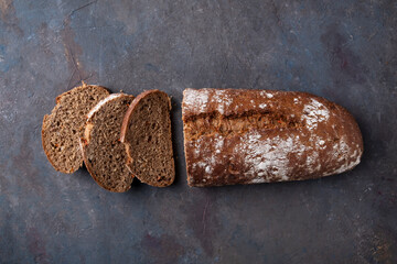 Top view of sliced bread on dark background.