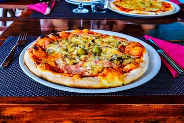 Pizza for dinner on a table in a restaurant.