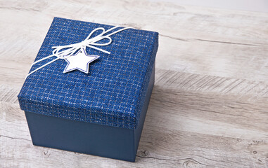 Blue  gift box with ribbon on the table