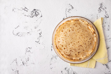 Thin pancakes on light background wth copy space. Top view