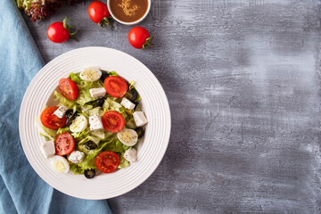 Top view of diet salad with fresh vegetables, lettuce, arugula and cheese. Space for text