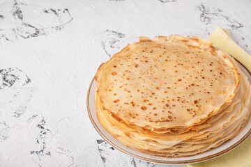Homemade thin pancakes on a plate. Copy space