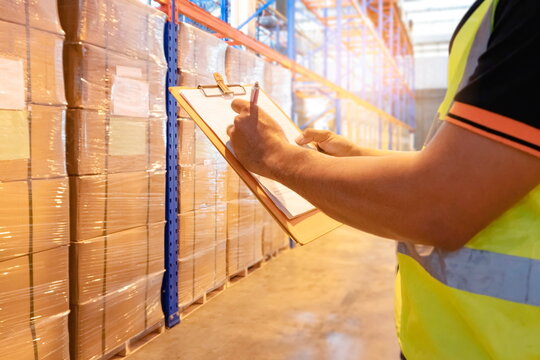 Workers Holding Clipboard Doing Inventory Management in The Warehouse. Supply Chain. Cargo Shipment. Shipping Warehouse Logistics.