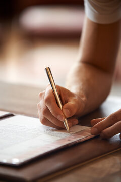 Man signing document with pen