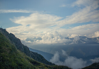 Landscape on mountains with clouds. Bird's eye view. Early, Sunny morning. Sochi. Krasnaya Polyana. A soft picture.