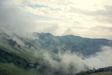 Landscape on mountains with clouds. Bird's eye view. Early, Sunny morning. Sochi. Krasnaya Polyana. A soft picture.