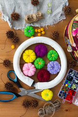 Felt pumpkins in bright autumn colors, scissors and accessories for crafts and handmade for decorative autumn wreath