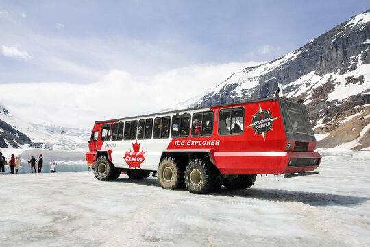 Jasper National Park, Canada - June 07, 2015: The red-white Ice Explorer, the snow coatch car carrying tourists to Athabasca Glacier to view the nature of the glacier.