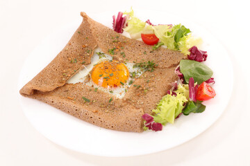 crepe with egg and lettuce on white background
