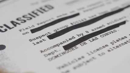 Close up. Hand erases sensitive text with black marker for censorship purpose. Classified information being erased or removed by government or military official before publication or released to press