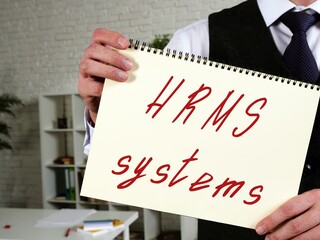 Business concept meaning Hrms Systems with phrase on the piece of paper.