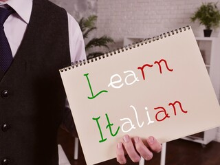 Business concept meaning Learn Italian with sign on the piece of paper.