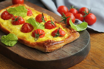 Fresh tomato tart, puff pastry topped with ricotta, cheese and cherry tomatoes