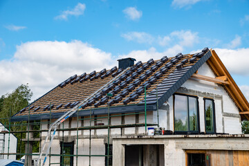 laying tiles on the roof of a single-family house