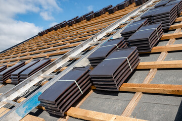 laying tiles on the roof of a single-family house