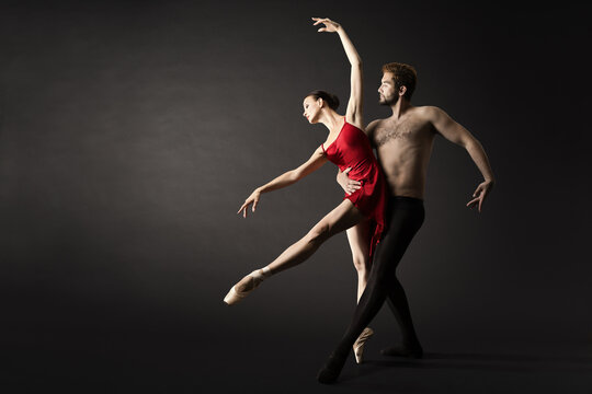 Ballet Dancers. Modern Ballerina Couple Posing over Gray Background