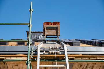 laying tiles on the roof of a single-family house