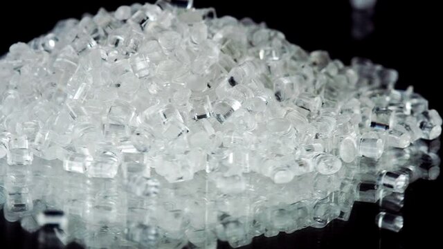 Close Up Clear Plastic Polymer Granules on black background