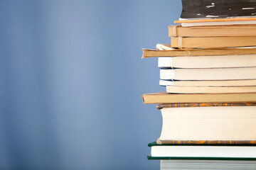 A stack of books in front of a blue background