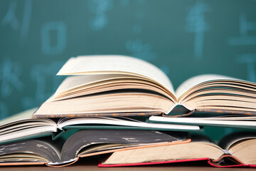 Opened book in front of blackboard