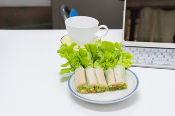 Salad vegetable roll on dish in work place,soft focus.