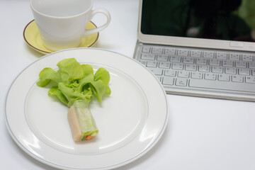 Salad vegetable roll on dish in work place,soft focus.