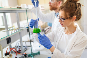 Woman student, scientist of chemistry working in laboratory
