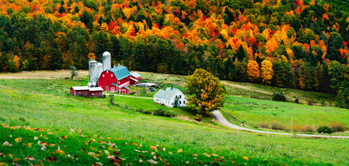 Rustic farm scene in rural vermont during autumn with fall colors changing and a bountiful harvest and a traditional American scene depicting home for the holidays - obrazy, fototapety, plakaty