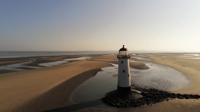 Talacre red domed lighthouse golden coastline low tide sunrise aerial wide orbit right view