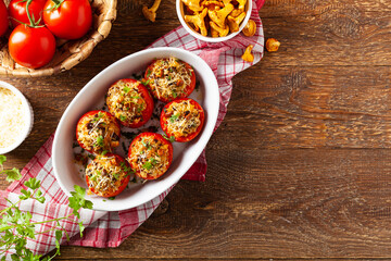 Baked stuffed tomatoes. Stuffed with chanterelles. Top view of the dish.