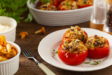 Baked stuffed tomatoes. Stuffed with chanterelles. Top view of the dish.