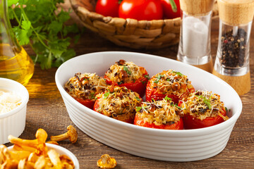 Baked stuffed tomatoes. Stuffed with chanterelles. Top view of the dish.