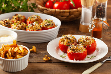 Baked stuffed tomatoes. Stuffed with chanterelles. Top view of the dish.