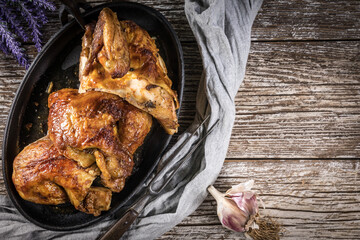 Quarters of fried chicken in a cast iron skillet.
