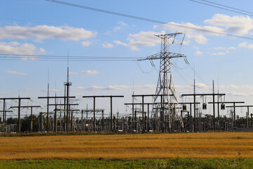 power plant, with many electrical supports and wires, as well as energy transformers