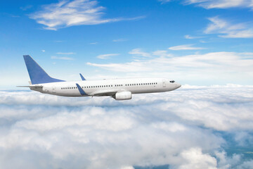 Side view of a flying passenger plane on clouds