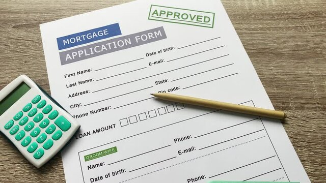 Mortgage application form on a wooden table.