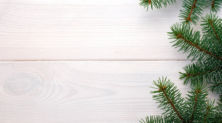 Christmas fir tree on a white wooden board and copy space for your text. Banner.Flat lay