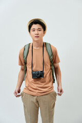 Young Asian tourist man lost his money and feel disappointed while standing over white background.