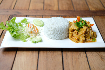 stir fried chicken curry sauce serving with rice and vegetable